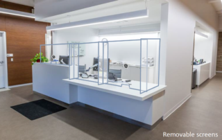 Removable plexiglass safety shields with speaker boxes at reception - after
