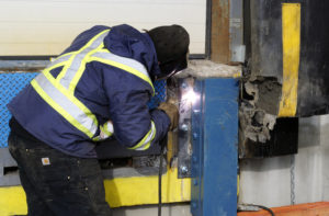technician welding dock bumper