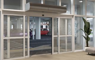 Architectural low profile air curtain sliding doors parking garage