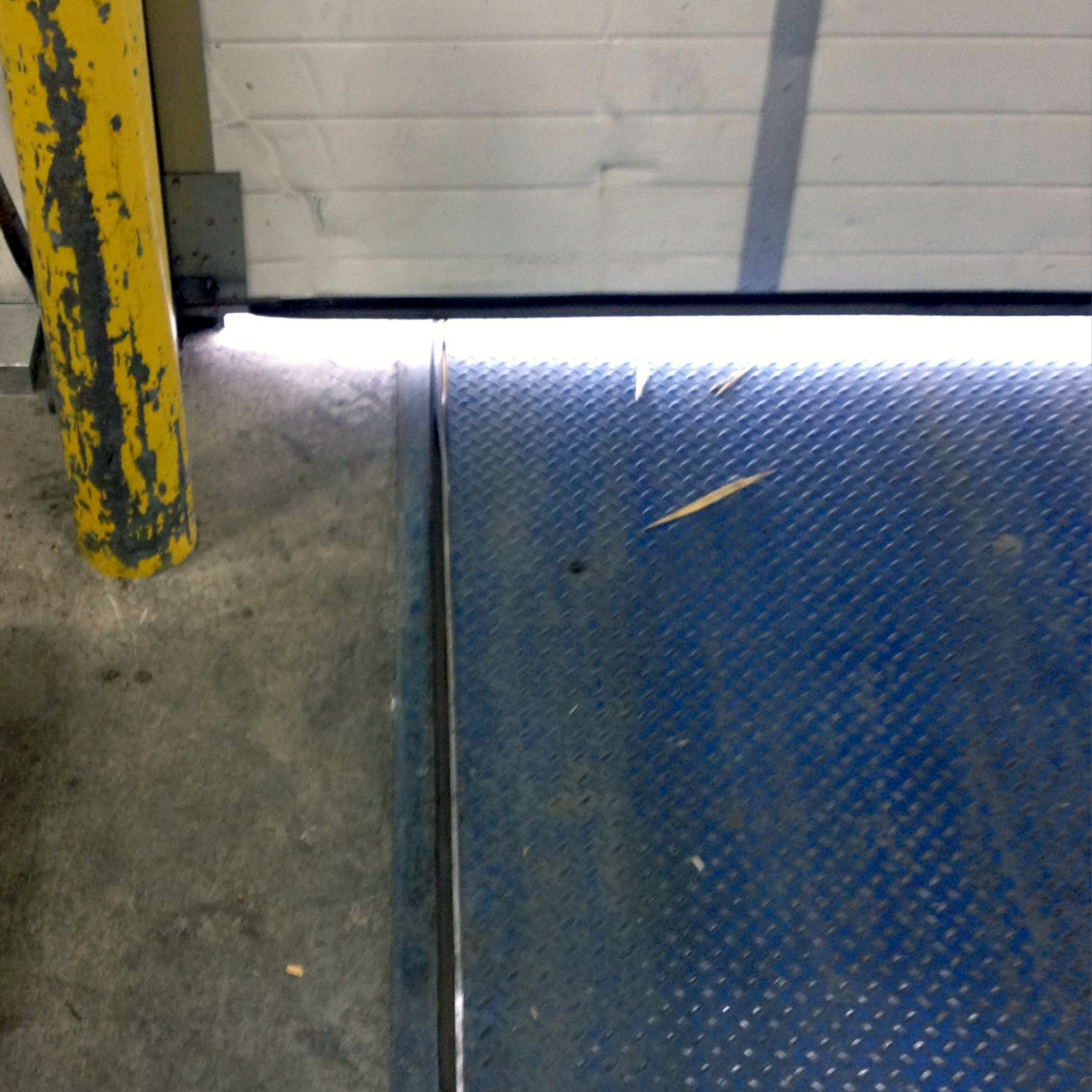 Breached Overhead Door without Weather Seal overhead door without weather seal breached white light pest infliration