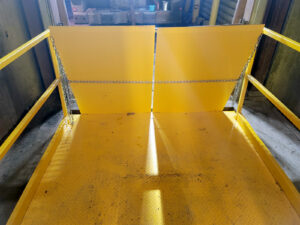 after yellow lift table on platform