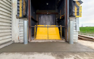 after yellow lift table with new bollards and concrete apron