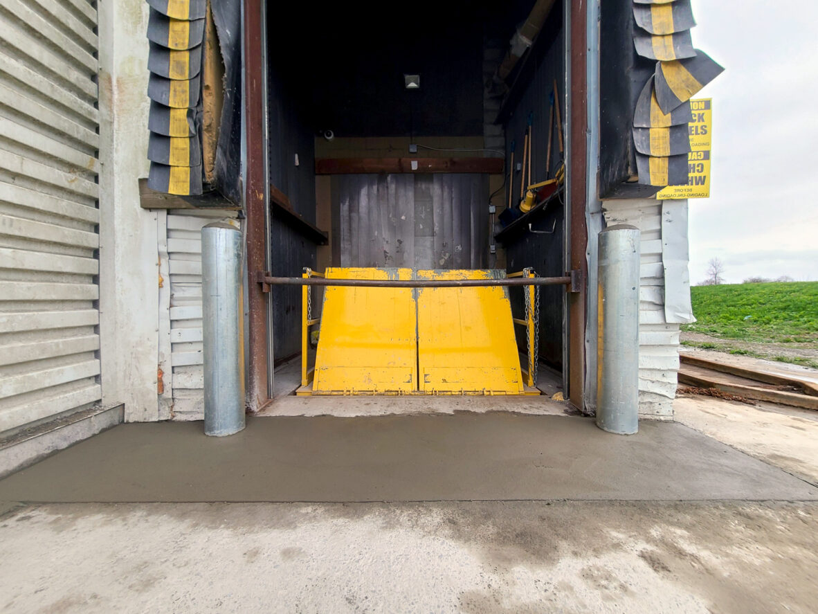 after yellow lift table with new bollards and concrete apron