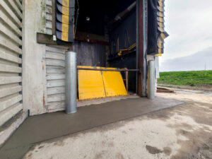 after yellow lift table at grocery store with new bollards and concrete apron