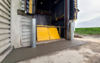 after yellow lift table at grocery store with new bollards and concrete apron
