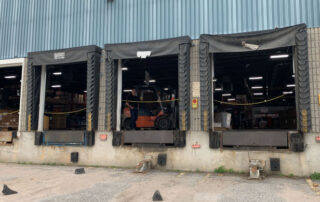 Three loading docks receiving shipping doors positions