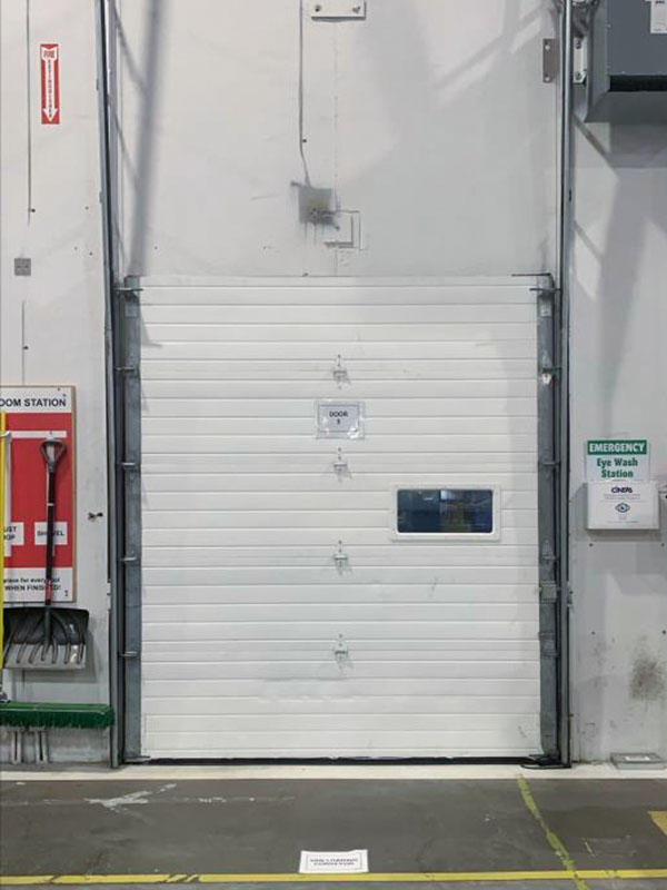 before sectional overhead door inside calgary alberta warehouse