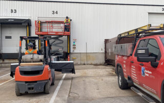 blue giant rain shroud dock canopy dock seal installation technicians forklift scissor lift red truck