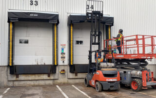 blue giant rain shroud dock canopy dock seal installation technicians forklift scissor lift