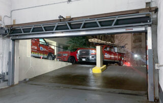 after toronto large wide parking garage hormann high-speed low headroom rubber door open inside NDS service trucks outside