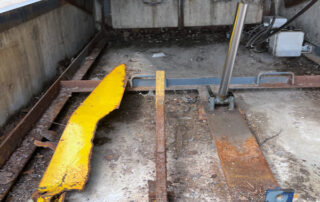 Etobicoke warehouse Before Rusted and worn exterior dock leveler debris rust dirt in dock pit